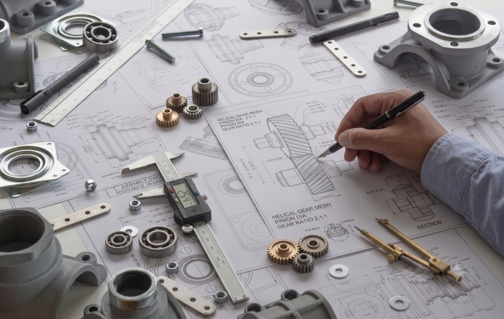 Engineering schematic with gears, bearings, calipers, and technical drawings