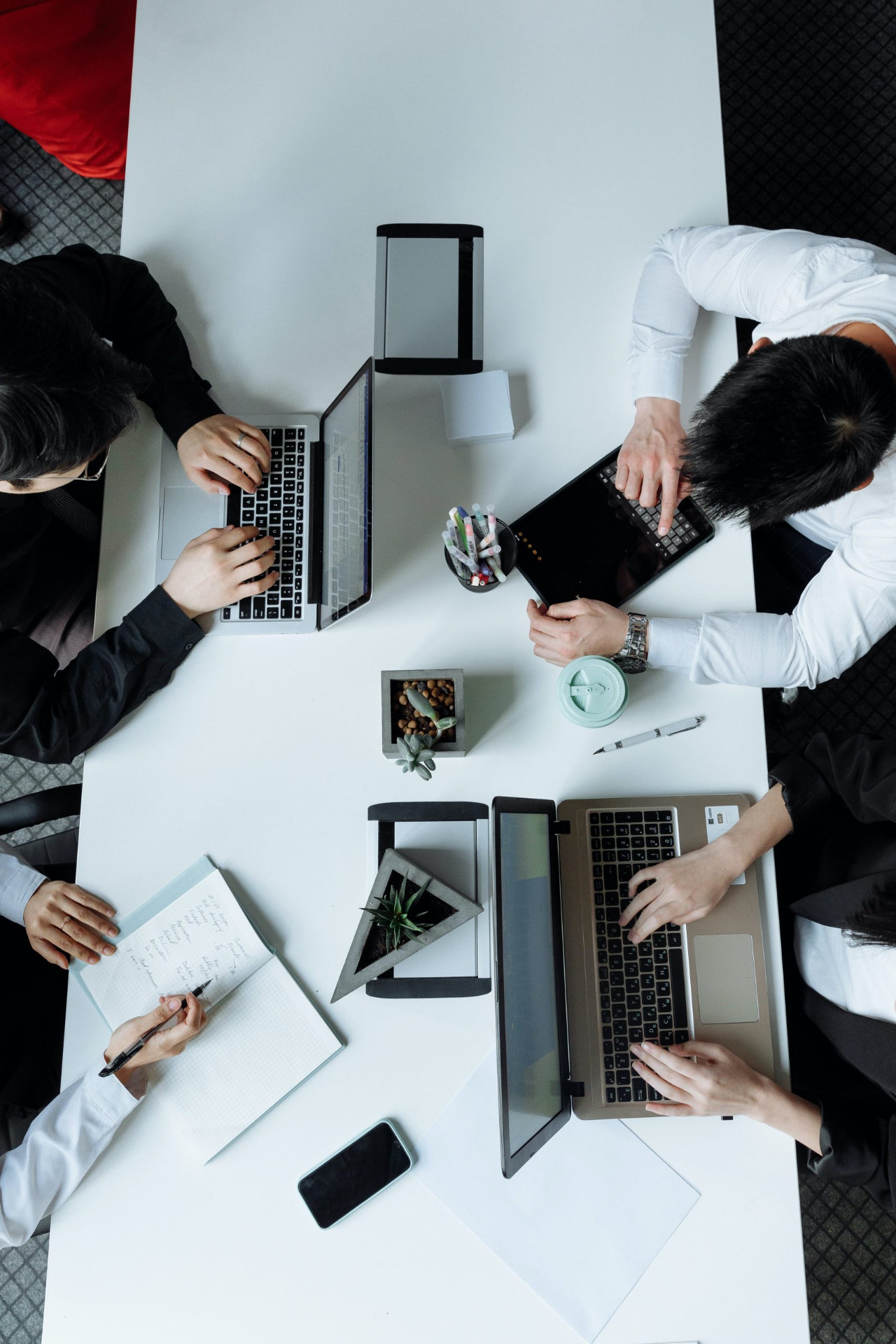 Aerospace consulting team collaborating around a shared workspace